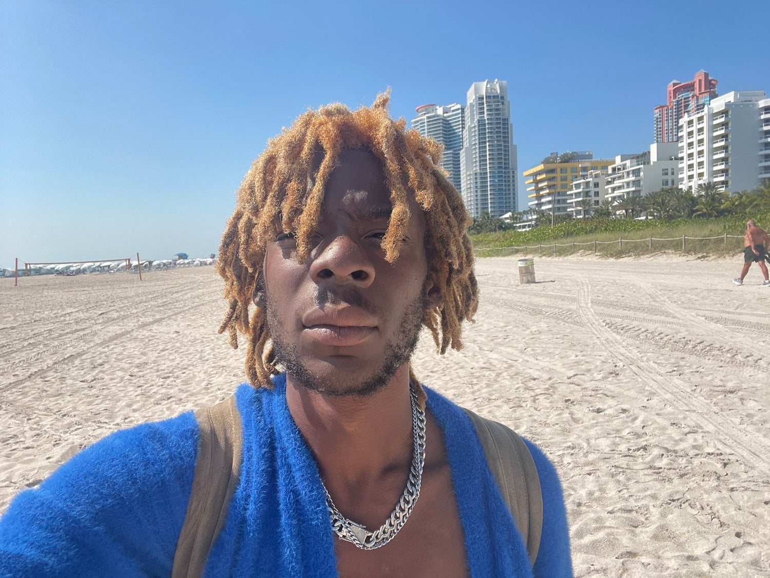 Kydale Outley on a Miami beach, the skyline behind him.